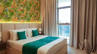 a hotel room with a bed and a large window at Modern 3BR Full Canal & Burj Khalifa View 2 in Dubai