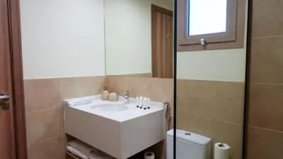 a bathroom with a sink and a mirror and a toilet at Stunning 2BR Canal View & Burj Khalifa 3 in Dubai