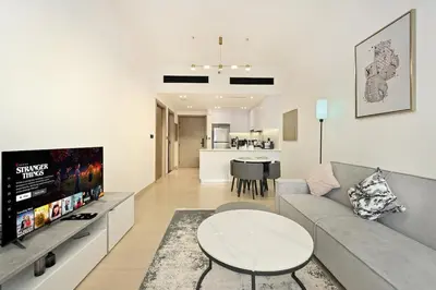 a living room with a couch and a table at Stunning 1 br modern luxury residence at JVC in Dubai