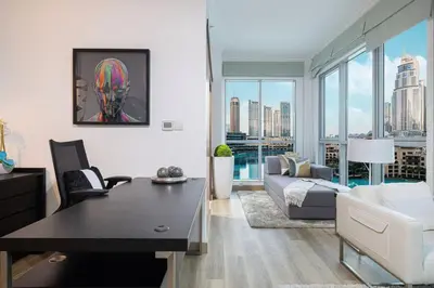 a living room with a couch and a table at Burj Khalifa and Fountain View 3BR in Dubai
