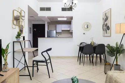 a living room with a table and chairs at 1Bedroom in Marina with Metro and Tram Access in Dubai