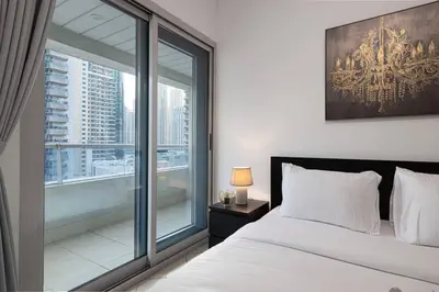 a bedroom with a bed and a large window at 1Bedroom in Marina with Metro and Tram Access in Dubai