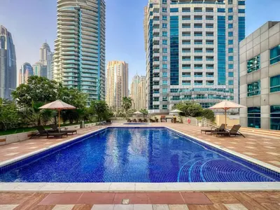 a swimming pool in a city with tall buildings at 1Bedroom in Marina with Metro and Tram Access in Dubai