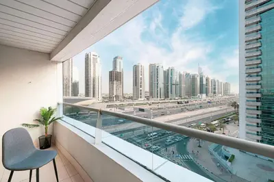 a balcony with a chair and a view of a city at 1Bedroom in Marina with Metro and Tram Access in Dubai