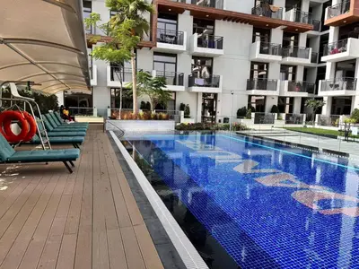 a swimming pool in the middle of a building at Stylish pool view 1BR in Barsha South sleeps 5 in Dubai