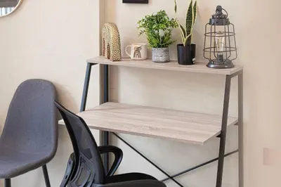 a wooden shelf with plants and a chair at Stylish pool view 1BR in Barsha South sleeps 5 in Dubai