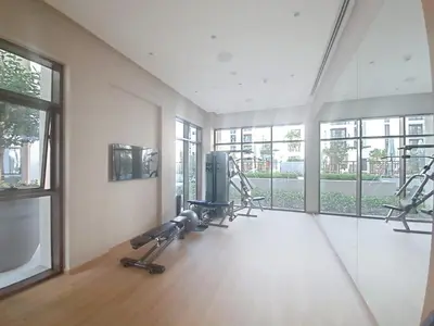 a gym with two treadmills and machines in a room at Vacationer l Contemporary 2 Bedroom l Pool, Gym, Private Beach Access in Dubai