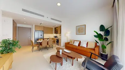 a living room with a couch and a table at Vacationer l Contemporary 2 Bedroom l Pool, Gym, Private Beach Access in Dubai