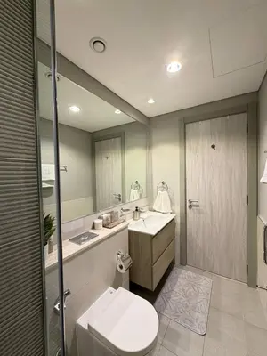 a bathroom with a sink and a toilet and a mirror at Zada Tower 1 Bedroom Apartment in Business Bay in Dubai
