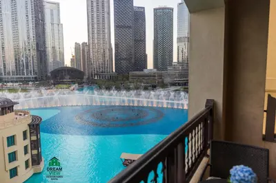 a view from a balcony of a fountain in a city at Full View Burj Khalifa and Fountains -Souk Al Bahar- Dream View holiday Home Rent in Dubai