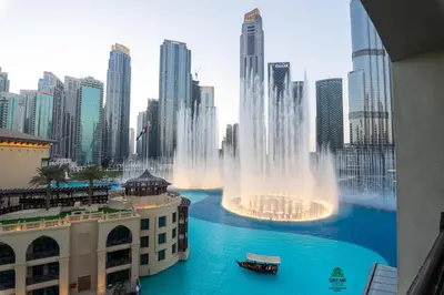 a large water fountain in the middle of a city at Full View Burj Khalifa and Fountains -Souk Al Bahar- Dream View holiday Home Rent in Dubai