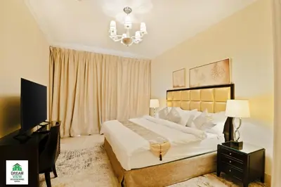 a bedroom with a bed and a desk and a television at Full View Burj Khalifa and Fountains -Souk Al Bahar- Dream View holiday Home Rent in Dubai