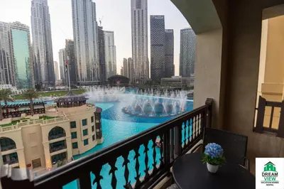 a balcony with a view of a fountain in a city at Full View Burj Khalifa and Fountains -Souk Al Bahar- Dream View holiday Home Rent in Dubai