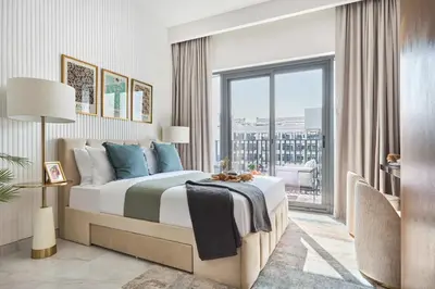 a bedroom with a bed and a large window at Frank Porter - Azizi Mirage 1 in Dubai