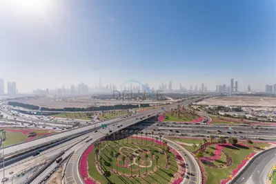 an overhead view of a highway with a city in the background at Sleek Modern Studio with Direct view of Dubai Skyline - Farhad Azizi Residence, Al Jaddaf by Deluxe Holiday Homes in Dubai