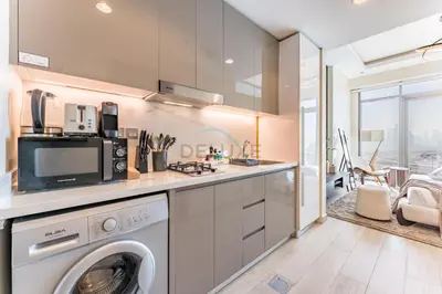 a kitchen with a washer and a washing machine at Sleek Modern Studio with Direct view of Dubai Skyline - Farhad Azizi Residence, Al Jaddaf by Deluxe Holiday Homes in Dubai