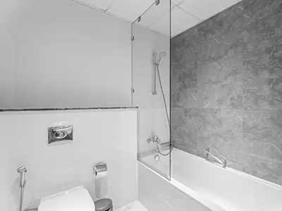 a bathroom with a shower and a toilet and a tub at Cozy and Elegant 1 BDR In Noura Tower-37 in Dubai