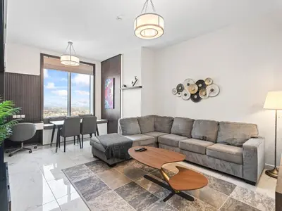 a living room with a couch and a table at Cozy and Elegant 1 BDR In Noura Tower-37 in Dubai