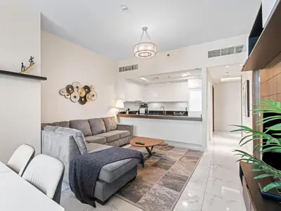 a living room with a couch and a table at Cozy and Elegant 1 BDR In Noura Tower-37 in Dubai