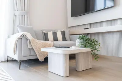 a living room with a couch and a coffee table at StayShort - Spacious Studio in Town Square Sleeps 2 in Nadd Shubayḩ