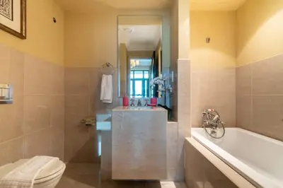 a bathroom with a tub and a toilet and a sink at Luxury Old Town Fountain View 2BHK front of Dubai Mall in Dubai