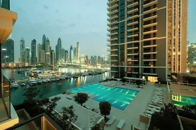 a view of a large swimming pool in a city at Beachfront 2BR Marina & Beach Views in Dubai
