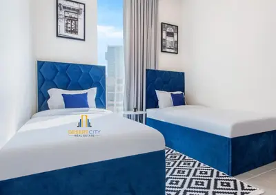two beds in a room with blue and white at Premium 2BR Downtown Dubai Near Burj & Dubai Mall Hosted by Desert City Stays in Dubai