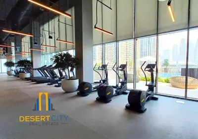 a gym with a row of treadmills in a building at Premium 2BR Downtown Dubai Near Burj & Dubai Mall Hosted by Desert City Stays in Dubai