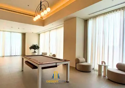 a ping pong table in a room with windows at Premium 2BR Downtown Dubai Near Burj & Dubai Mall Hosted by Desert City Stays in Dubai