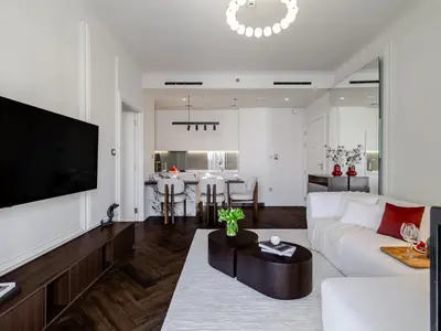a living room with a white couch and a table at Stunning High-Floor 1BR Burj Khalifa & Canal Views in Dubai