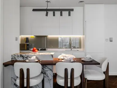 a kitchen with a table with chairs and a counter top at Stunning High-Floor 1BR Burj Khalifa & Canal Views in Dubai