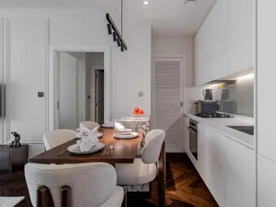 a dining room with a table and chairs in a kitchen at Stunning High-Floor 1BR Burj Khalifa & Canal Views in Dubai