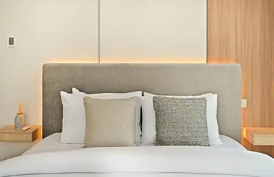 a bedroom with a bed with white pillows at Curated High-Floor 2BR Sofa Bed Marina Water View in Dubai