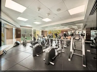 a gym with treadmills and cardio equipment in a building at Curated High-Floor 2BR Sofa Bed Marina Water View in Dubai