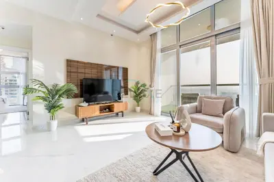 a living room with a tv and a couch and a table at Walking Distance To JBR Beach, The Walk, And Marina Mall, With Easy Access To The Metro And The Vibrant Marina Nightlife - DEC Towers 2, Dubai Marina by Deluxe Holiday Homes in Dubai