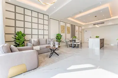 a living room with a couch and a table at Walking Distance To JBR Beach, The Walk, And Marina Mall, With Easy Access To The Metro And The Vibrant Marina Nightlife - DEC Towers 2, Dubai Marina by Deluxe Holiday Homes in Dubai