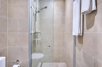 a shower with a glass door in a bathroom at STAY BY LATINEM Luxury 1BR Holiday Home CVR A2604 near Burj Khalifa in Dubai