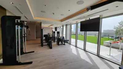 a room with a gym with a flat screen tv at STAY BY LATINEM Luxury 1BR Holiday Home CVR A2604 near Burj Khalifa in Dubai