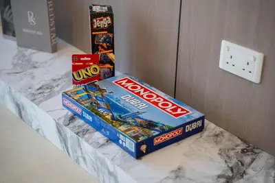 a counter with a box of lego and a monopoly board at New Downtown Bldg Near Burj View with Infinity Pool and SkyGym in Dubai