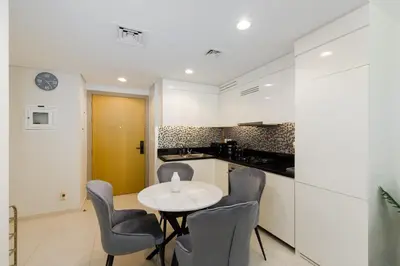 a kitchen with a table and chairs in a room at Aykon City Tower C, Business Bay - Onelink in Dubai