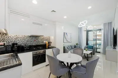 a kitchen and dining room with a table and chairs at Aykon City Tower C, Business Bay - Onelink in Dubai