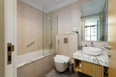 a bathroom with a sink and a toilet and a tub at Aykon City Tower C, Business Bay - Onelink in Dubai