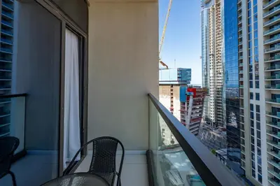 a balcony with two chairs and a view of a city at Aykon City Tower C, Business Bay - Onelink in Dubai