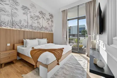 a bedroom with a bed and a large window at New, Bright & Modern 4BR Villa in Tilal Al Furjan in Dubai