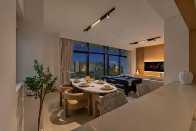 a kitchen and dining room with a table and a piano at New, Bright & Modern 4BR Villa in Tilal Al Furjan in Dubai