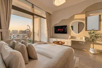 a bedroom with a large bed and a large window at New, Bright & Modern 4BR Villa in Tilal Al Furjan in Dubai