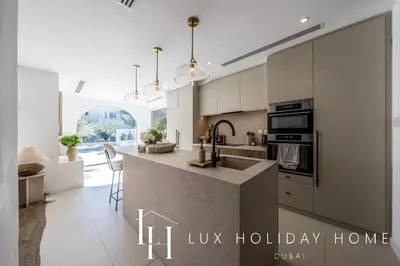 a kitchen with a large island in a luxury home at LUX The Serene Springs Villa 3 in Dubai