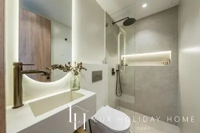 a bathroom with a shower and a toilet and a sink at LUX The Serene Springs Villa 3 in Dubai