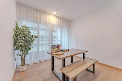a table and a bench in a room with a window at HAVN - 2 bedroom in Elite Residences, Dubai Marina in Dubai