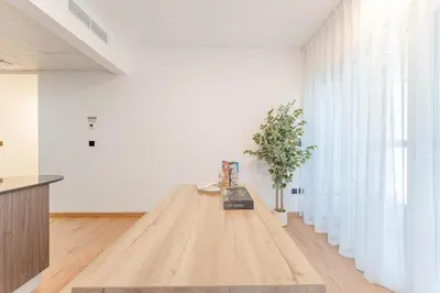 a table in a room with a plant on it at HAVN - 2 bedroom in Elite Residences, Dubai Marina in Dubai